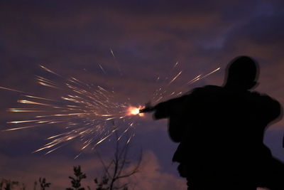 Low angle view of silhouette man against sky at night