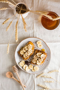 Ready to eat bruschettas with honey, banana and chocolate on a plate on the table. vegetarian food