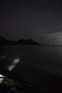 Scenic view of sea against sky at night