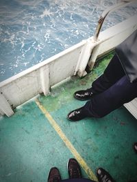 Low section of man standing in water