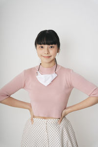 Portrait of a smiling young woman against white background