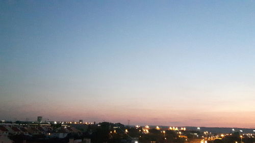 High angle view of illuminated buildings against sky at sunset