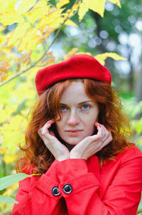 Young happy woman with red hair, freckles, blue eyes in beret in autumn park, smiling. lifestyle