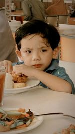 Portrait of cute boy eating food