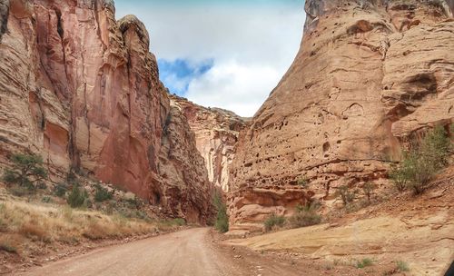 Road amidst rock formation against sky