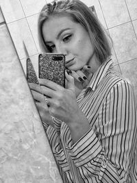 Portrait of woman holding camera