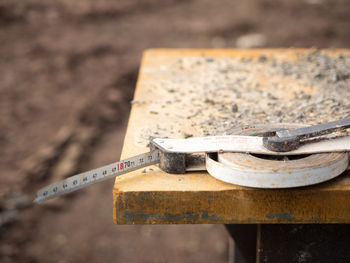 Close-up of tape measure on table at workshop