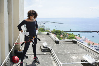 Side view of woman standing on railing