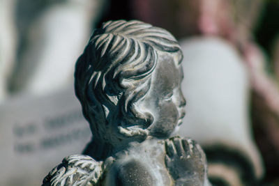 Close-up of angel statue in cemetery