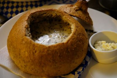 Close-up of sour rye soup in bread bowl on table