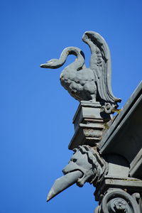 Low angle view of statue against clear blue sky