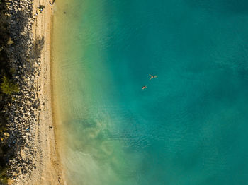 High angle top down view of beach and lake