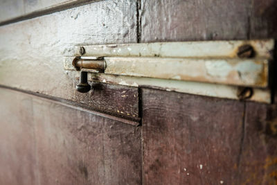 Close-up of latch on old door