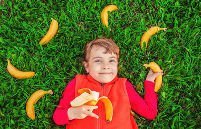 High angle view of cute boy with toy on grassy field