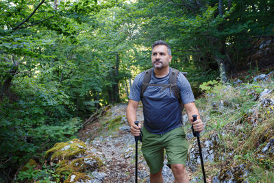 Portrait of man standing in forest