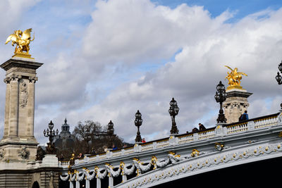 Low angle view of statue against cloudy sky