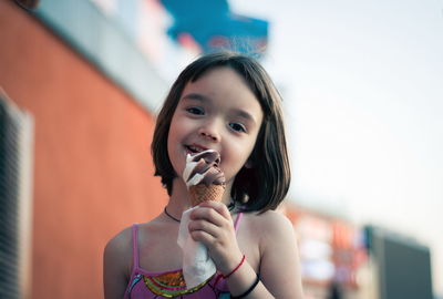 Little girl eating ice cream outdoors