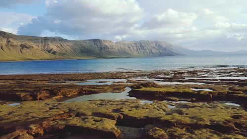 Scenic view of sea against cloudy sky