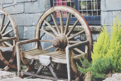 Old abandoned wheel against wall