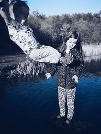 Woman standing by lake