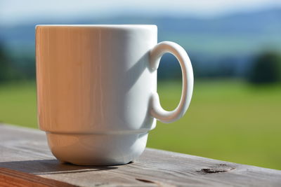 Close-up of coffee cup on wooden table