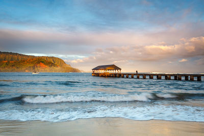 View of beach against cloudy sky