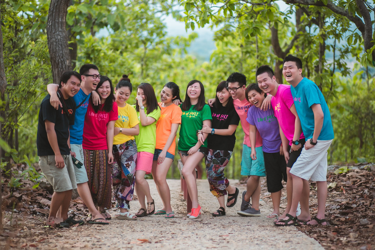 young adult, young women, happiness, looking at camera, tree, smiling, casual clothing, day, outdoors, togetherness, portrait, medium group of people, leisure activity, fun, excitement, cheerful, real people, forest, friendship, standing, full length, lifestyles, nature, adult, people