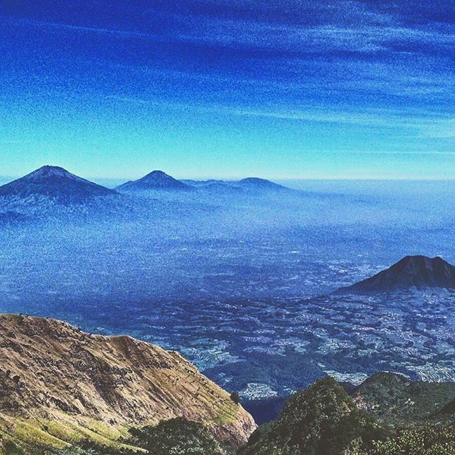 mountain, tranquil scene, scenics, tranquility, beauty in nature, mountain range, blue, sky, nature, idyllic, landscape, water, non-urban scene, majestic, outdoors, sea, cloud - sky, remote, cloud, physical geography