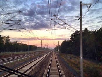 Railroad track against cloudy sky