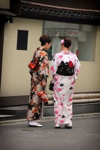 Full length of woman standing by railing