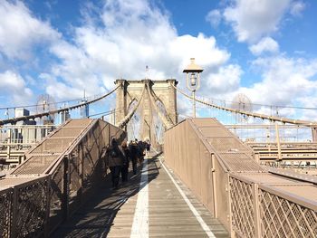 Low angle view of suspension bridge against sky