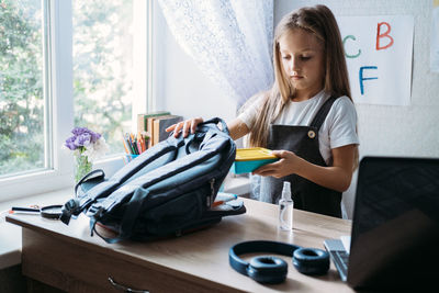 Back to school, schoolchildren hygiene, safety precautions after coronavirus. the schoolgirl is