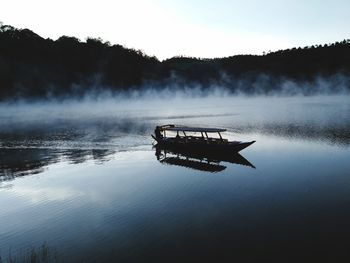 Boat in lake against sky