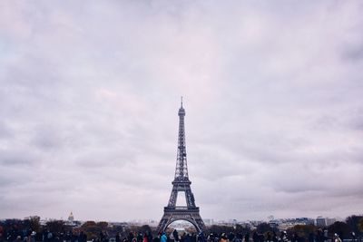 Low angle view of eiffel tower against cloudy sky