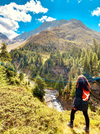 Rear view of woman standing on mountain