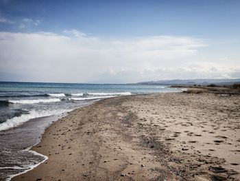 View of beach against cloudy sky