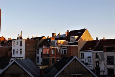 Houses in town against clear sky
