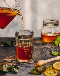 Drink pouring in glass on table