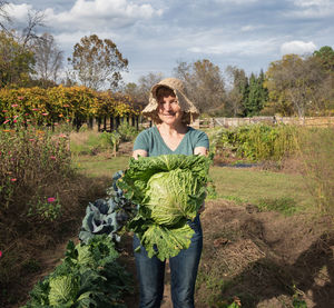 Portrait of smiling woman standing in farm