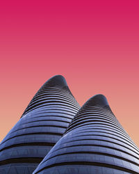 Low angle view of modern buildings against clear sky during sunset