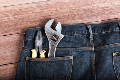 Work tools in jeans pocket on table