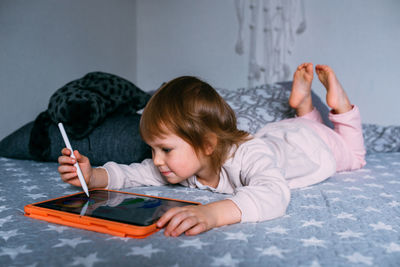 High angle view of girl drawing on book at home