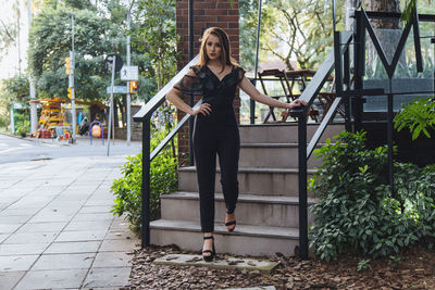 Portrait of woman standing on steps