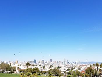 Cityscape against clear blue sky