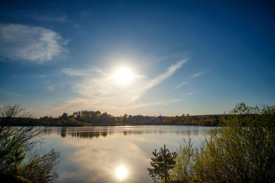 Scenic view of river against sky at sunset