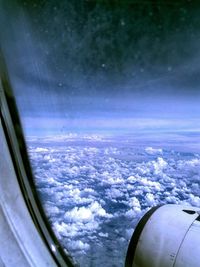 Cropped image of airplane wing over landscape