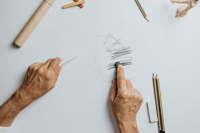 Cropped hand of woman sketching on paper