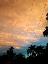 Low angle view of silhouette trees against sky during sunset