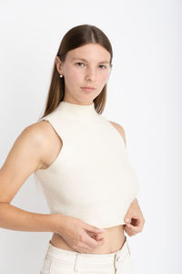 Portrait of young woman against white background