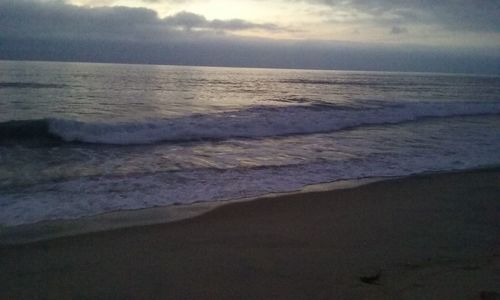 Scenic view of beach against sky during sunset